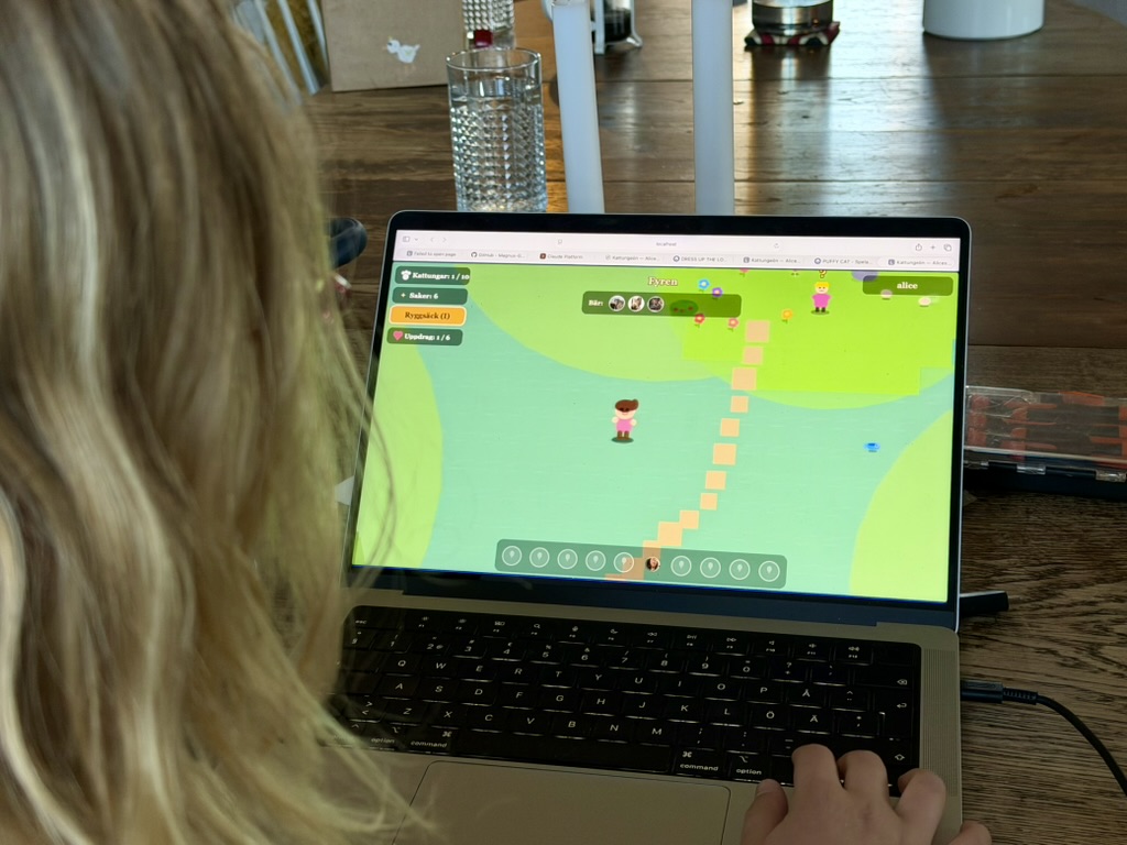 My daughter playing Kattungen, a browser game she built with Claude Code